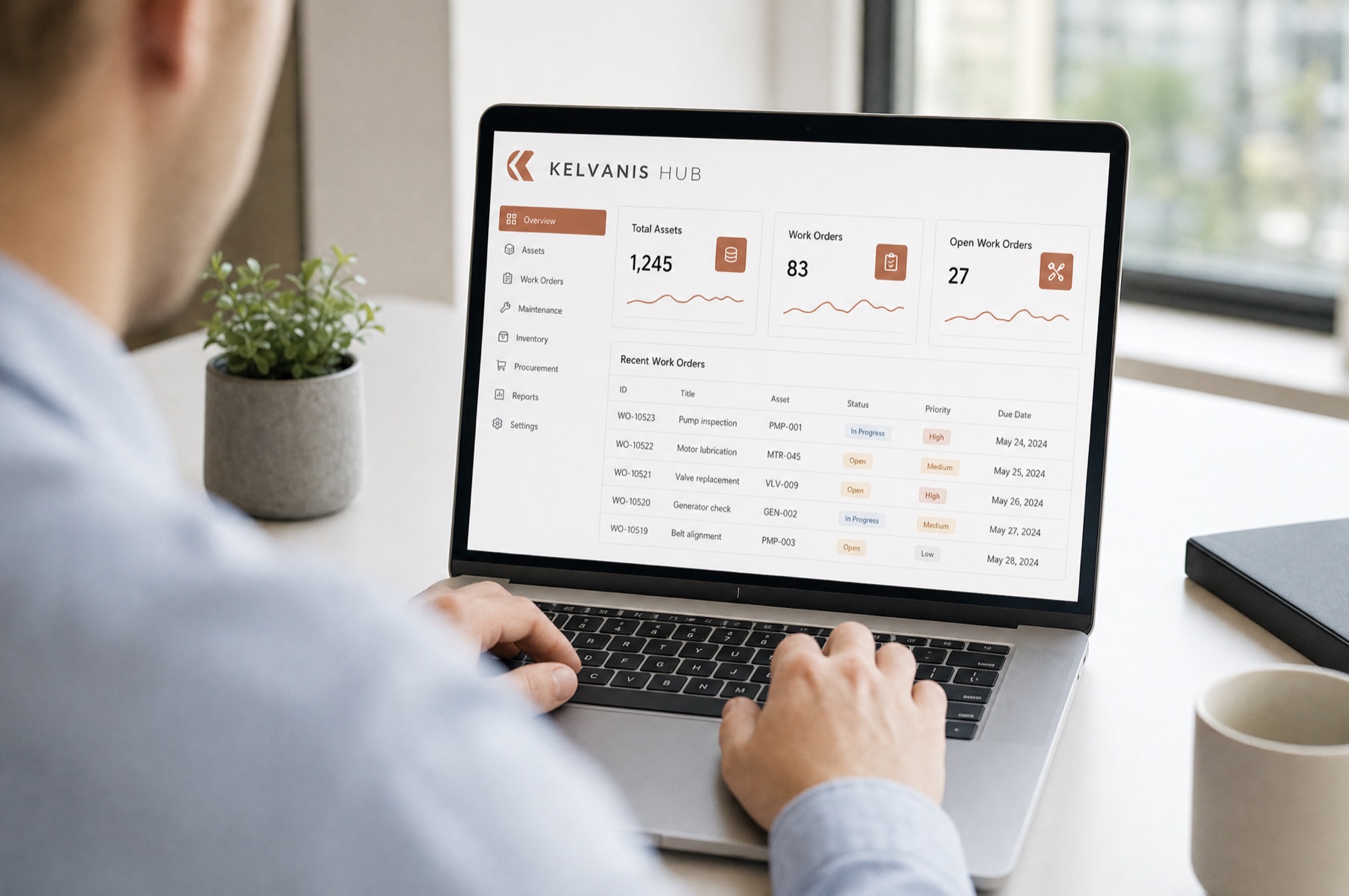 A team member reviewing the Kelvanis Hub dashboard on a laptop